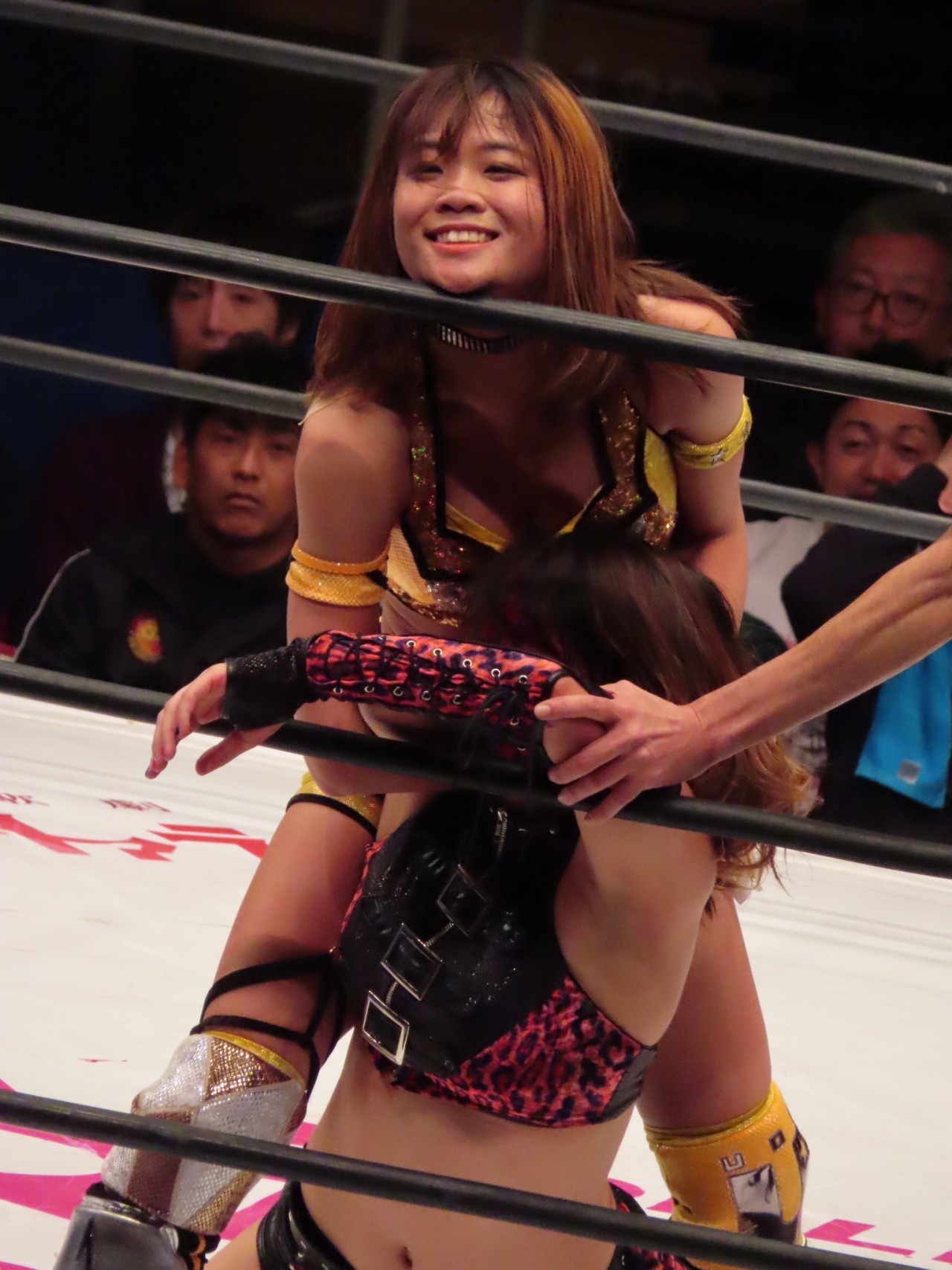 Arisa Hoshiki smiling whilst applying a cobra clutch submission hold to her opponent, Utami Hayashishita