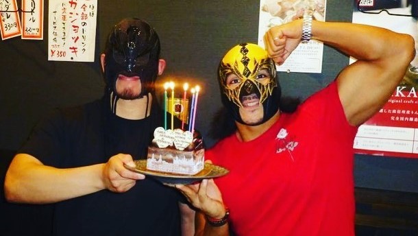 An image of Shun and Diamante celebrating their tag team anniversary with cake